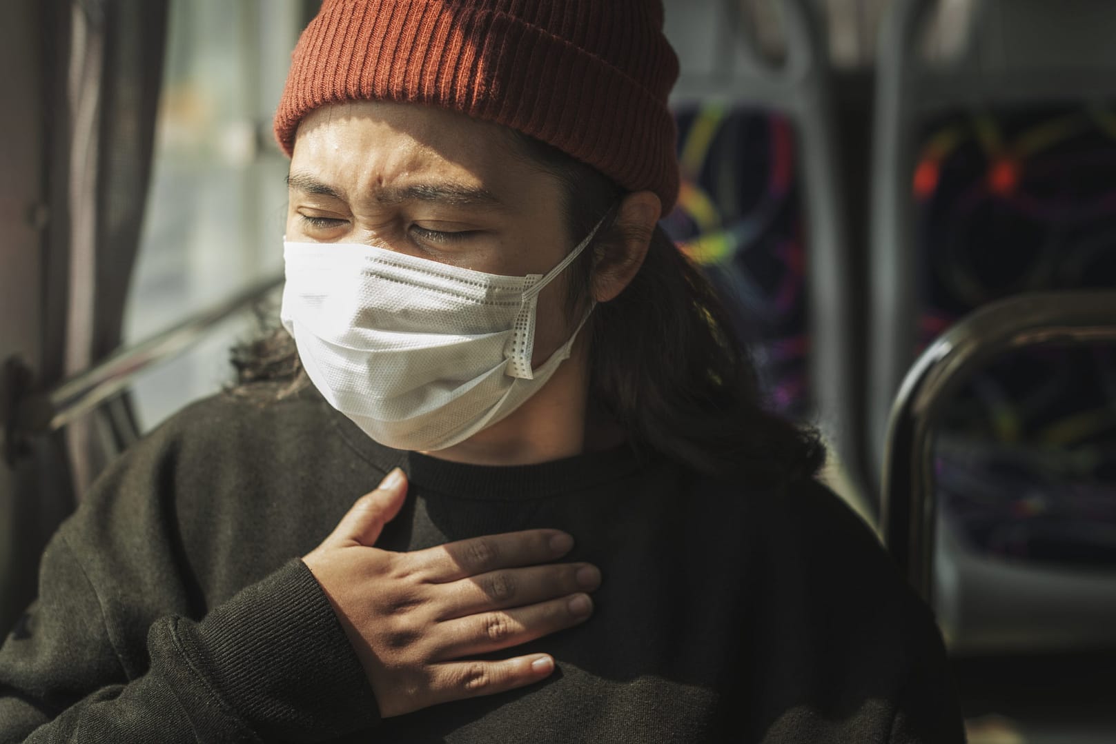 Sick woman in a mask having a difficulty breathing during coronavirus pandemic