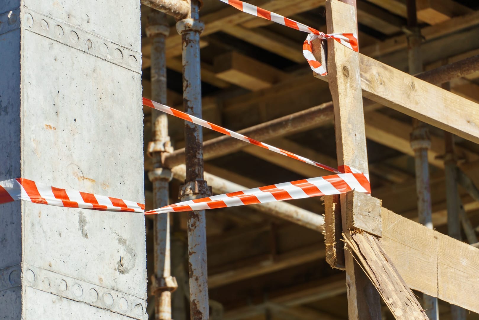 An outdoor construction site. Construction of a new building. Block construction, reinforced concrete beams and wooden floors and roofs.